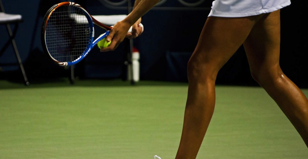 Tennis player striking the ball